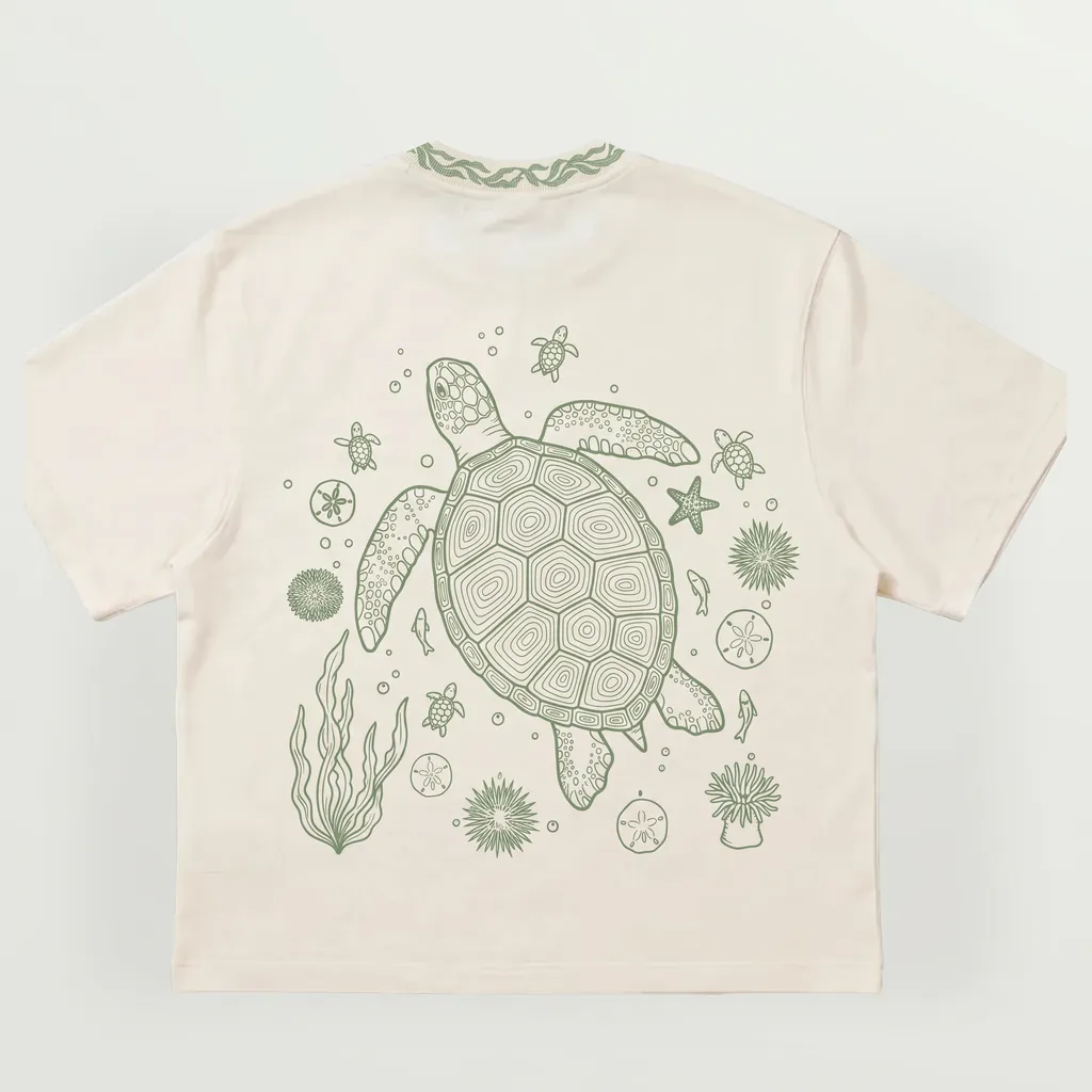 Mockup of the turtle tee, back: the sea turtle with baby turtles, sand dollars, urchins and kelp, in sage green line art on cream