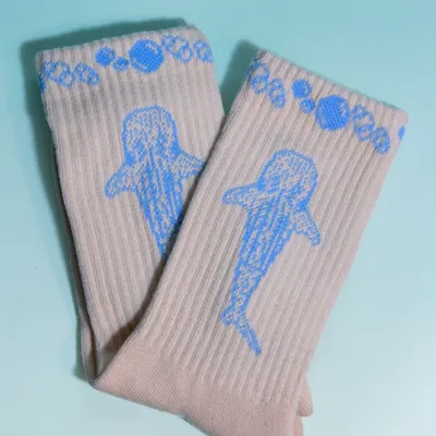 A pair of whale shark socks laid flat