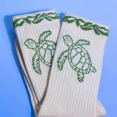 A pair of turtle socks laid flat